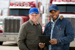 Workers in front of their trucks