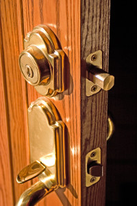 A deadbolt lock on a wooden door