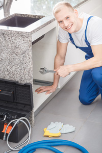 Plumber working on a sink