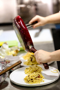 chef serving pasta