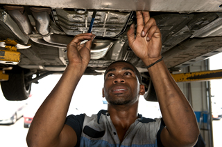 become-a-mechanic-2 Automotive mechanic working on the underside of a vehicle